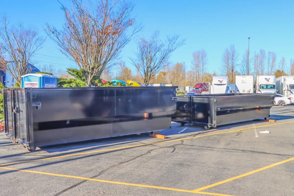 Professional dumpster rental service with roll-off container on residential driveway in Hatfield